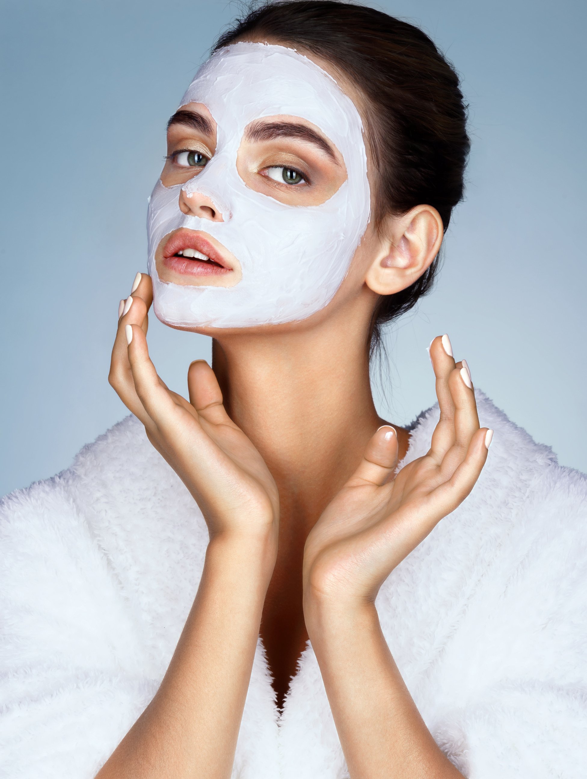 Attractive young woman with moisturizing facial mask.