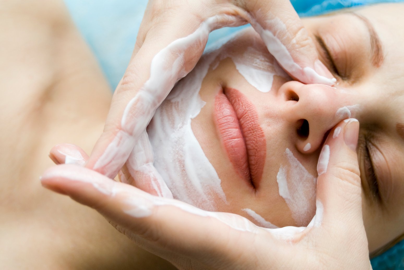 Woman in beauty salon receiving relaxing facial